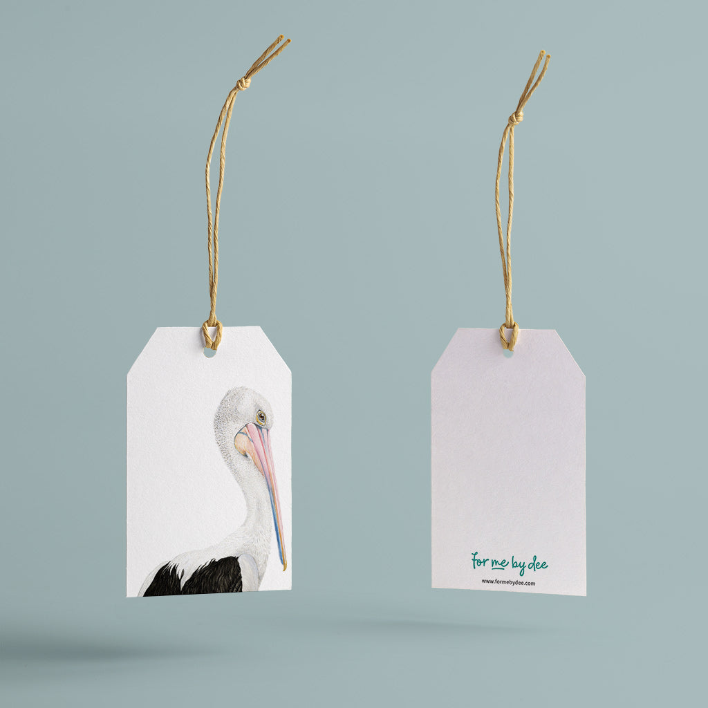australian pelican bird painted on gift tag with twine string on blue background