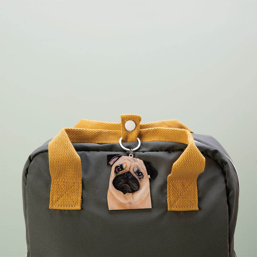 fawn pug dog watercolour artwork enamel keychain on green bag with mustard handles