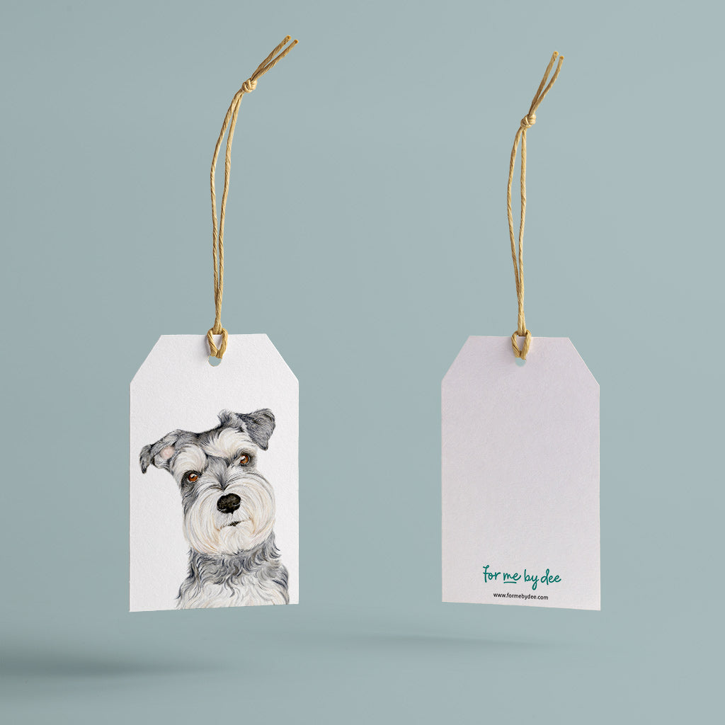 salt and pepper schnauzer dog gift tag with twine string on blue background