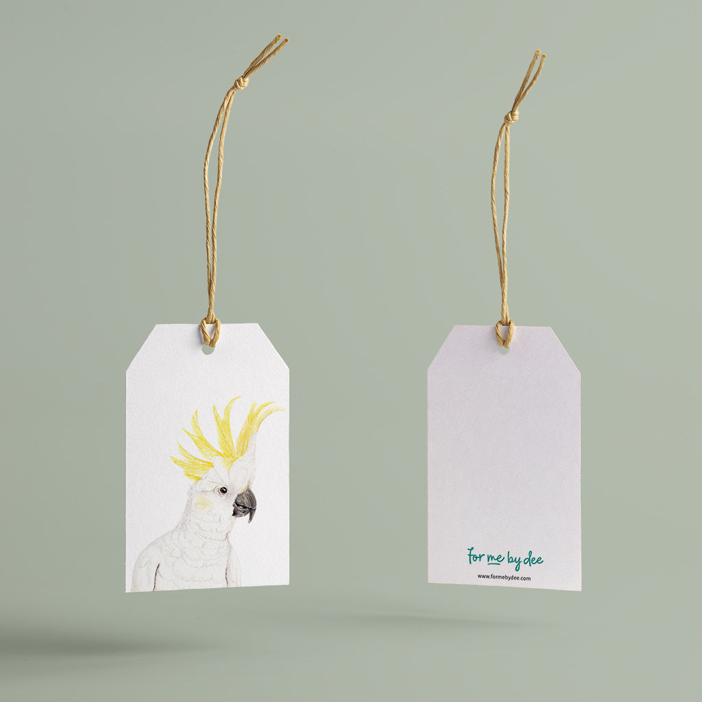 sulphur crested cockatoo australian bird gift tag with twine string on green background